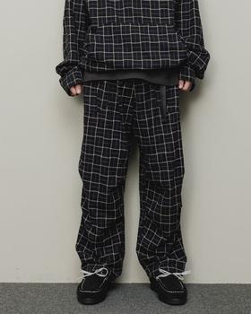 A man wearing a checkered baloriginal matching jacket and pants
