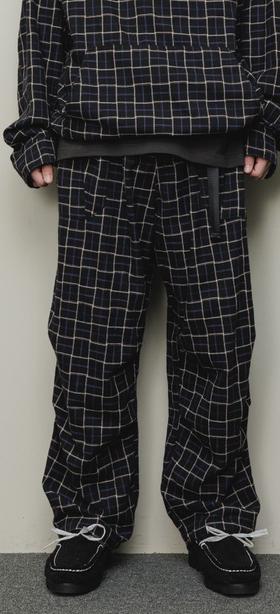 A man wearing a checkered baloriginal matching jacket and pants
