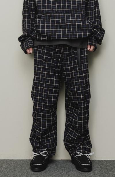 A man wearing a checkered baloriginal matching jacket and pants