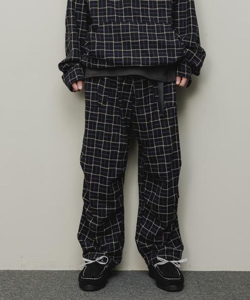 A man wearing a checkered baloriginal matching jacket and pants