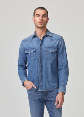 A man wearing a Citizen of Humanity denim jacket and matching pants