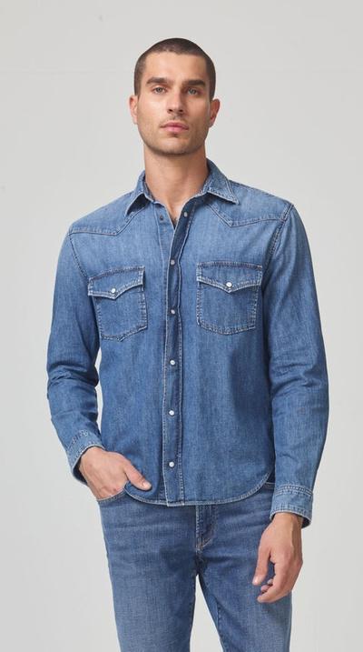 A man wearing a Citizen of Humanity denim jacket and matching pants