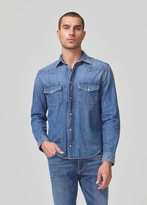 A man wearing a Citizen of Humanity denim jacket and matching pants