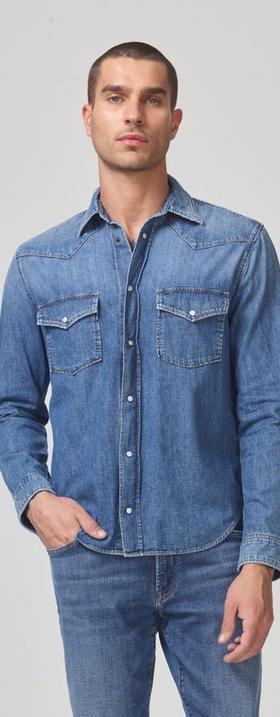 A man wearing a Citizen of Humanity denim jacket and matching pants