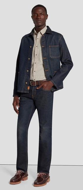 A man wearing 7 of All Mankind denim pants and matching jacket