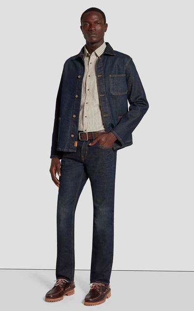 A man wearing 7 of All Mankind denim pants and matching jacket