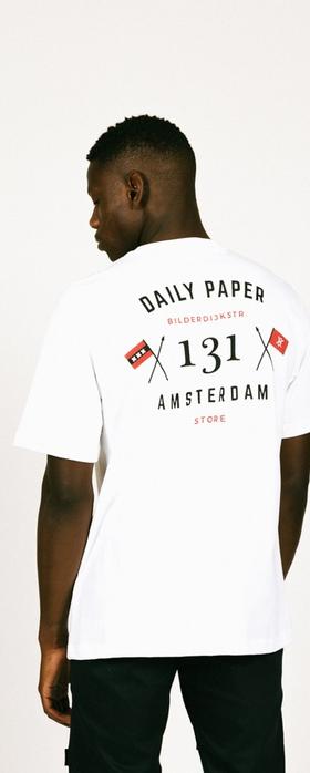 A man wearing a Daily Paper Amsterdam white t-shirt