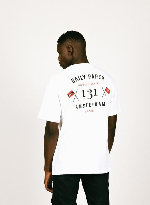A man wearing a Daily Paper Amsterdam white t-shirt