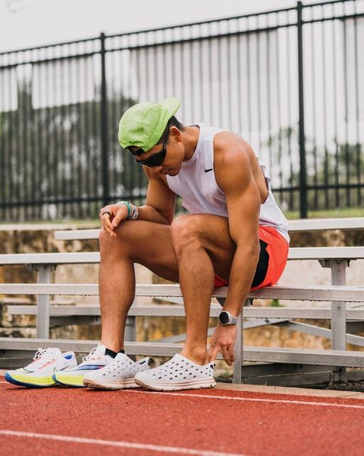 A man wearing a pair of Kane slip-ons at a running track