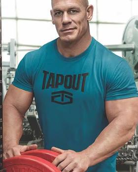 Jon Cena wearing a tapout shirt in aqua while weightlifting