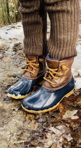 A man wearing a pair of Sperry Duck Boots in the snow