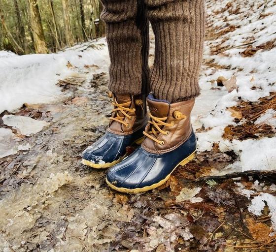 A man wearing a pair of Sperry Duck Boots in the snow