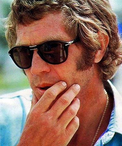 A man wearing a classic pair of Persol sunglasses