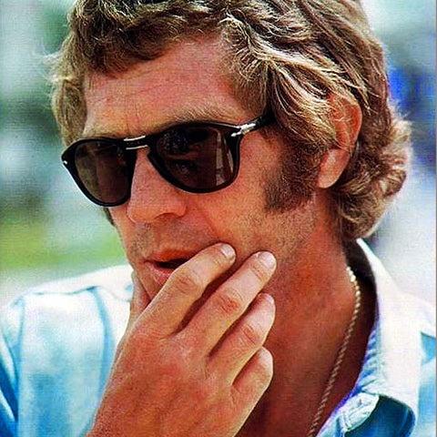 A man wearing a classic pair of Persol sunglasses