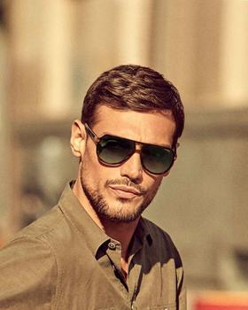 A man wearing a pair of black Carrera sunglasses