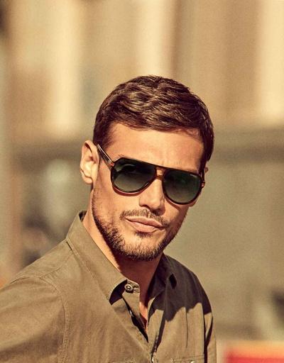 A man wearing a pair of black Carrera sunglasses