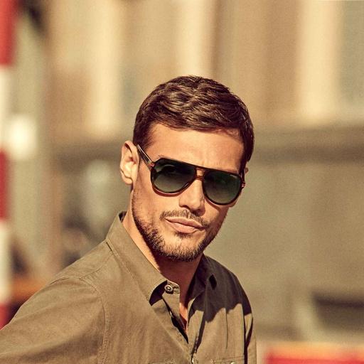 A man wearing a pair of black Carrera sunglasses
