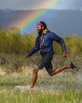 A man wearing a pair of Bedrock Sandals running