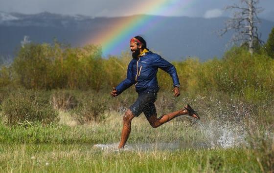 A man wearing a pair of Bedrock Sandals running