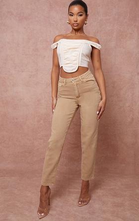 A woman wearing a PrettyLittleThing brown pants and white top