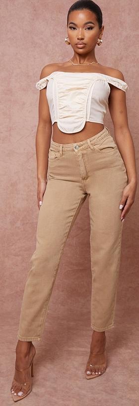 A woman wearing a PrettyLittleThing brown pants and white top