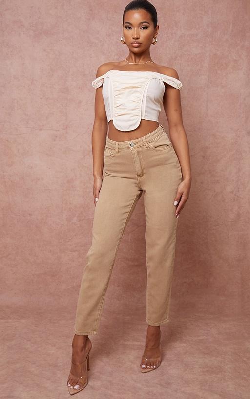 A woman wearing a PrettyLittleThing brown pants and white top