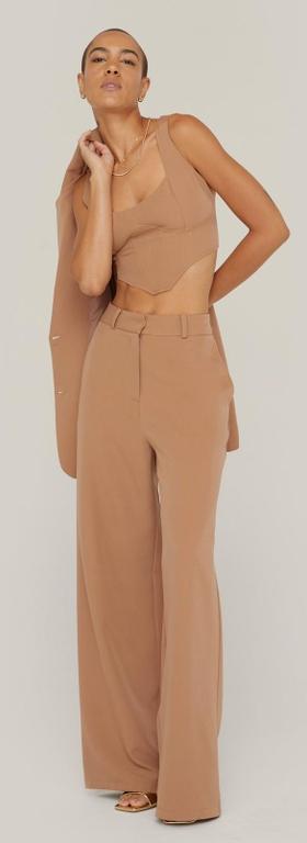 A woman wearing a NastyGal brown outfit