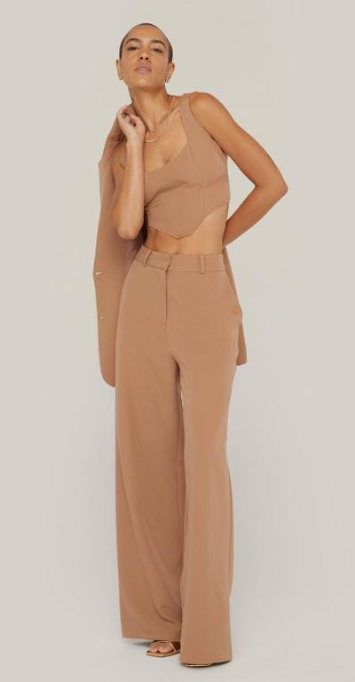 A woman wearing a NastyGal brown outfit