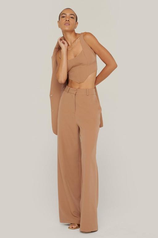 A woman wearing a NastyGal brown outfit