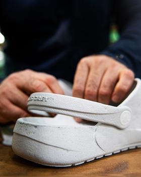 A man showcasing a pair of Ales grey slip-on shoes