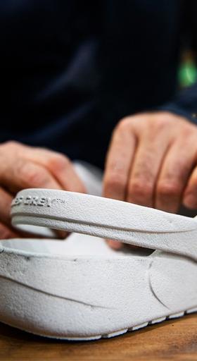A man showcasing a pair of Ales grey slip-on shoes