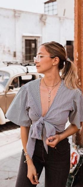 A woman wearing a Zaful blouse and outfit in grey