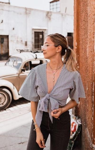 A woman wearing a Zaful blouse and outfit in grey