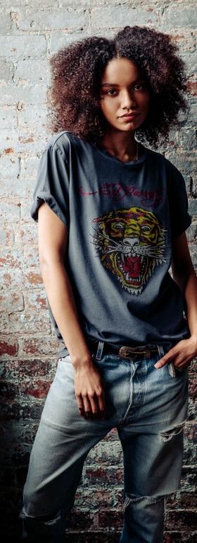 A woman wearing an Ed Hardy tattoo t-shirt in grey