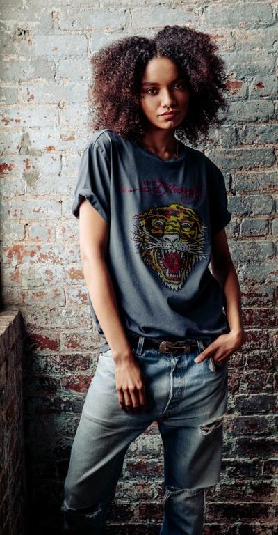 A woman wearing an Ed Hardy tattoo t-shirt in grey