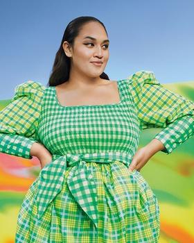 A woman wearing a green Target dress in green and yellow