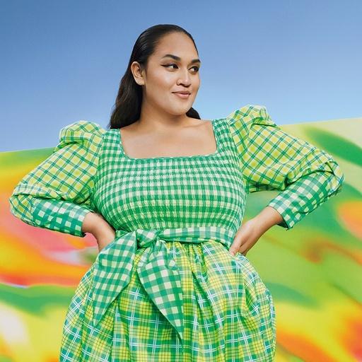 A woman wearing a green Target dress in green and yellow