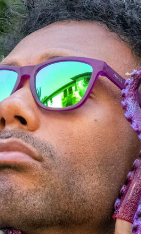 A man wearing Purple Goodr sunglasses