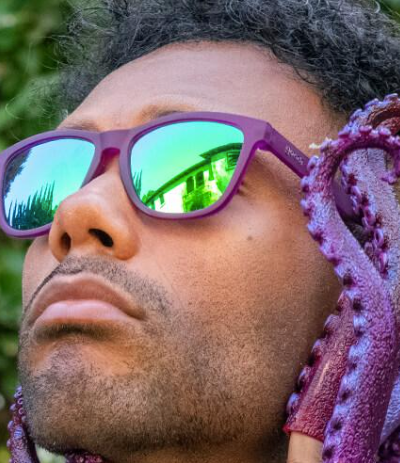 A man wearing Purple Goodr sunglasses