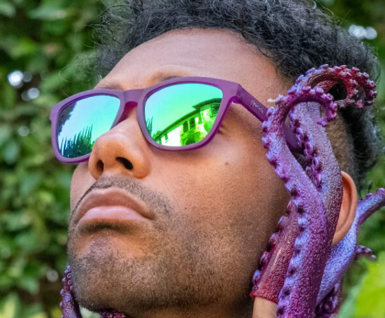 A man wearing Purple Goodr sunglasses