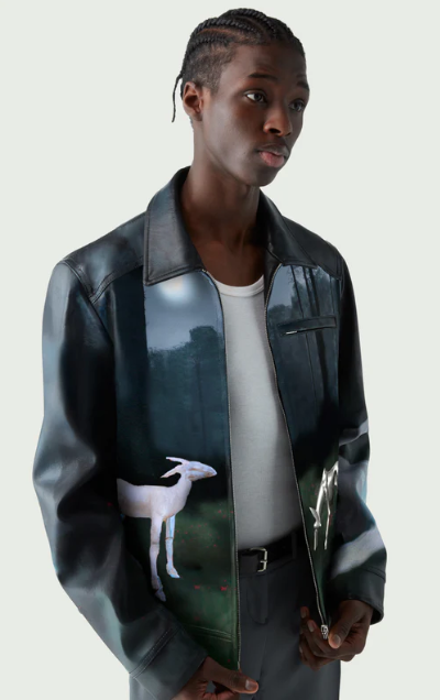 A man wearing a Coperni leather jacket with deer images on it