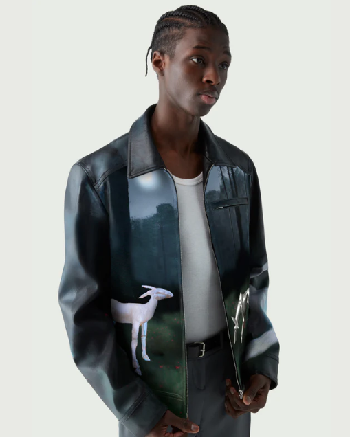 A man wearing a Coperni leather jacket with deer images on it