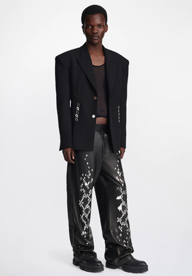 A man wearing an edgy Dion Lee jacket and oversize punk pants
