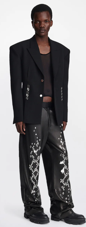 A man wearing an edgy Dion Lee jacket and oversize punk pants