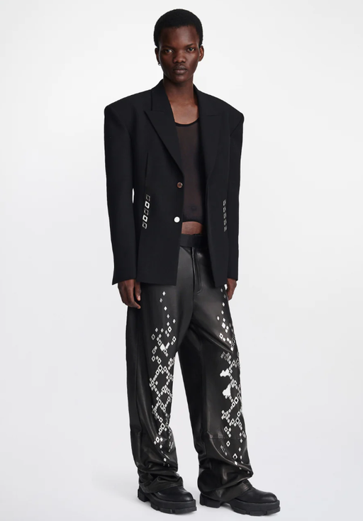A man wearing an edgy Dion Lee jacket and oversize punk pants