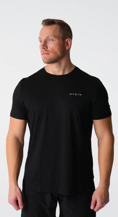 A man wearing a tight-fitting black NVGTN logo t-shirt