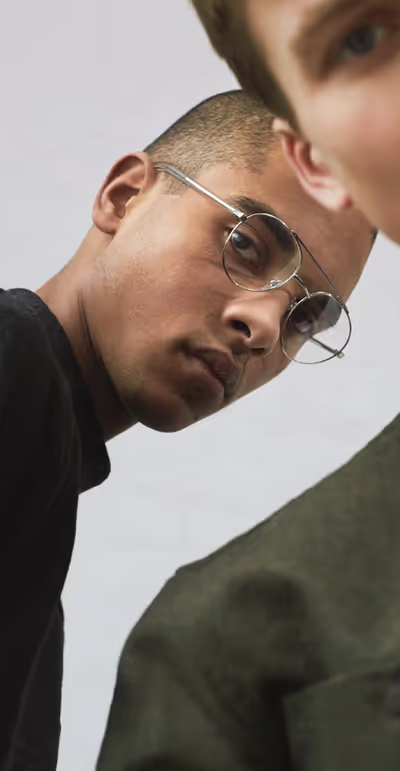 A man wearing a pair of RetroSuperFuture clear silver eyeglasses