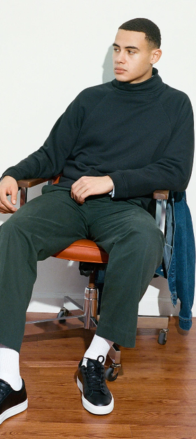 A man wearing a pair of Black Great Shoes with white soles