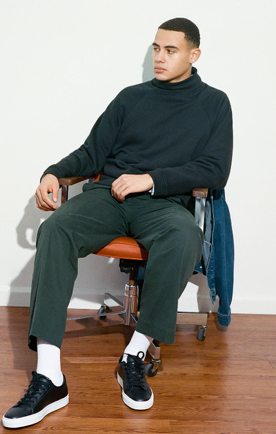 A man wearing a pair of Black Great Shoes with white soles