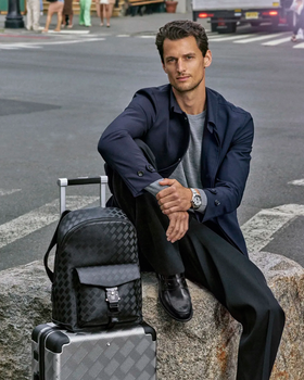 A man wearing a Montblanc suit in navy blue with a grey shirt